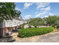 Charming townhomes with manicured landscaping and a glimpse of the cityscape in the background at 216 S Clarkson St # E, Charlotte, NC 28202