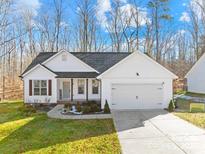 Charming single-Gathering home with white siding, a front-facing garage, and a well-manicured lawn at 242 Delview Dr, Cherryville, NC 28021
