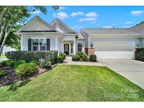 Charming single-story home featuring manicured landscaping and an attached two-car garage at 28129 Song Sparrow Ln, Fort Mill, SC 29707