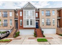 Attractive brick townhome with a well-manicured lawn and attached garages at 3044 Luke Crossing Dr, Charlotte, NC 28226