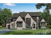 Beautiful brick two-story home with a landscaped front yard at 306 Sugar Maple Ln, Matthews, NC 28104