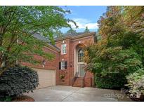 Charming brick home featuring an arched entrance, well-maintained landscaping and a two-car garage at 3524 Rhett Butler Pl, Charlotte, NC 28270