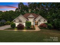 Stunning home featuring manicured landscaping, a charming fountain, and elegant architectural details at 400 Maymont Dr, Cramerton, NC 28032