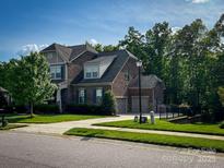 Traditional brick home with a well-maintained lawn and a two-car garage at 4006 Tremont Dr, Indian Trail, NC 28079