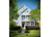 Charming two-story home boasts a welcoming front porch and well-manicured lawn at 4516 Night Heron Ln, Charlotte, NC 28211