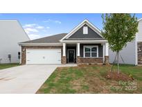 Charming single-story home featuring a stone and gray shingle facade, well-manicured lawn, and a two-car garage at 4619 Harris Elliot Rd, Lincolnton, NC 28092