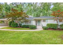 Charming one-story home featuring a well-maintained lawn, stylish shutters, and mature landscaping at 5162 Lincrest Pl, Charlotte, NC 28211