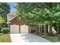 Charming brick home with a two-car garage and a well-maintained front yard at 8221 Brookings Dr, Charlotte, NC 28269