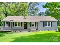 Charming single-story home featuring a covered front porch and well-maintained lawn at 983 Willowbrook Ave, Rock Hill, SC 29730