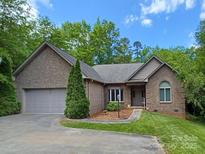 Charming single-story brick home with a well-manicured lawn, two-car garage, and inviting curb appeal at 1061 Nw 14Th Avenue Nw Dr, Hickory, NC 28601