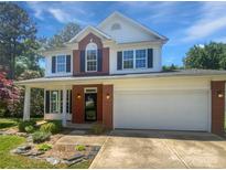 Charming two-story home featuring a two-car garage, complemented by a well-manicured lawn and beautiful landscaping at 1184 Lempster Nw Dr, Concord, NC 28027