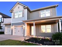 Charming two-story home with a two-car garage, complemented by an inviting landscaped front yard at 161 Old Harbor Dr, Mount Gilead, NC 27306