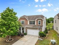 Charming two-story home featuring a two-car garage, well-maintained landscaping, and beautiful curb appeal at 2042 Newport Dr, Fort Mill, SC 29707
