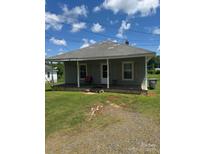 Charming single-story home with a front porch and a well-maintained lawn under a bright blue, sunny sky at 206 13Th St, Belmont, NC 28012