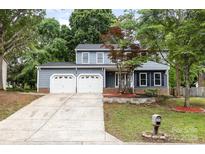 Charming two-story home featuring a two-car garage, landscaped front yard, and inviting curb appeal at 2112 Flint Glenn Ln, Charlotte, NC 28262