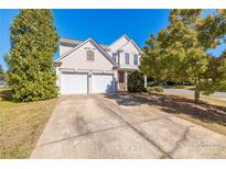 Charming two-story home with a well-maintained front yard and a two-car garage at 2802 Azalea Hills Dr, Charlotte, NC 28262