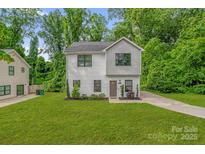 Charming two-story home with a well-manicured lawn and fresh landscaping at 2908 Burgess Dr, Charlotte, NC 28208