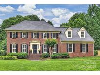 Beautiful two-story brick home with a well-manicured lawn and mature landscaping, offering classic curb appeal at 5508 Kincross Ln, Charlotte, NC 28277