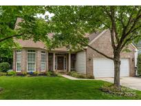 Charming brick home with a well-manicured lawn and inviting front entrance with a 'Welcome' sign at 5656 Cambridge Bay Dr, Charlotte, NC 28269