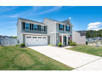 Beautiful two-story home with a spacious driveway and well-maintained front yard landscaping at 5812 Camp Sw Ct, Concord, NC 28025