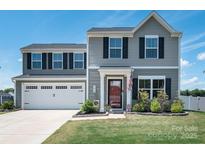 Charming two-story home featuring a well-manicured lawn and a spacious two-car garage at 5812 Camp Sw Ct, Concord, NC 28025