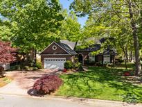 Charming brick home with lush landscaping, mature trees, and a well-manicured lawn at 617 Peace Haven Rd, Kannapolis, NC 28083