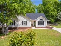 Charming home featuring a well-maintained lawn, manicured landscaping, and classic architectural details at 7122 Marlin St, Gastonia, NC 28056