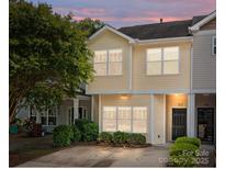 Inviting two-story townhouse with a well-maintained lawn and a welcoming front entrance at 112 St Vincent Pl, Mount Holly, NC 28120