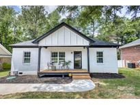 Charming white brick home with a cozy front porch, perfect for enjoying the outdoors at 141 Ole Eastpointe Dr, York, SC 29745