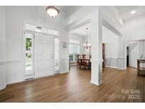 Bright foyer with hardwood floors, a front door with sidelights, and an adjacent dining area at 146 Burtons Barn Rd, Mooresville, NC 28115