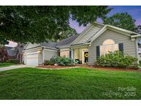 Charming single-story home with a well-manicured lawn and inviting front entrance with a beautiful front flowerbed at 146 Burtons Barn Rd, Mooresville, NC 28115