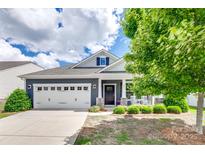 Charming single-Gathering home featuring a well-manicured lawn, two-car garage, and inviting curb appeal at 217 Barberry Dr, Belmont, NC 28012