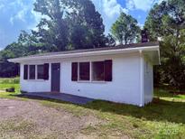 Charming home featuring dark shutters, a concrete walkway, and a neatly maintained yard at 2634 E Greenbriar Rd, Statesville, NC 28625