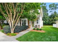Charming home with a lush front yard and inviting entrance with decorative stone accents and a small sitting area at 541 River Park Rd, Belmont, NC 28012