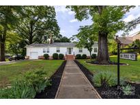 Charming single-story home with landscaped front yard and inviting walkway leading to the entrance at 80 Pine St, Badin, NC 28009