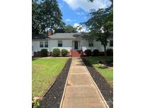 Charming single-story home with a welcoming front porch and well-manicured lawn at 80 Pine St, Badin, NC 28097