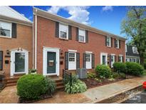 Charming brick townhome with well-maintained landscaping and black shutters at 8306 Knights Bridge Rd, Charlotte, NC 28210