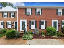 Charming brick townhome with black shutters and landscaped front yard at 8306 Knights Bridge Rd, Charlotte, NC 28210
