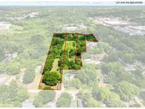 Aerial view showcasing the approximate lot lines of a spacious and heavily wooded property at 84 Sumner Nw Ave, Concord, NC 28027