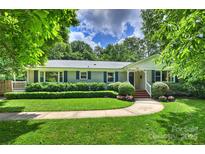 Charming single-story home with manicured lawn, walkway, and inviting front porch at 901 Scaleybark Rd, Charlotte, NC 28209