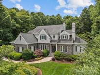 Stately home with stone accents, lush landscaping, and a symmetrical design providing outstanding curb appeal at 9831 Sedgefield Dr, Waxhaw, NC 28173
