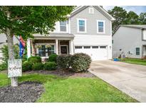 Charming two-story home with stone accents, a two-car garage, and landscaped front yard at 120 Tranquil Ct, Locust, NC 28097