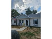 Inviting single-story home featuring a charming front porch and manicured lawn at 132 Swimmers Ln, Salisbury, NC 28146