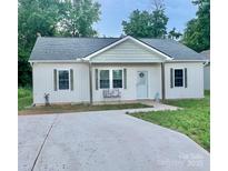 Charming single-story home with a covered porch, tidy yard, and concrete driveway at 132 Swimmers Ln, Salisbury, NC 28146