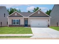 Charming single-story home featuring stone accents, a two-car garage, and a well-manicured front lawn at 1510 Doran Ter, Richburg, SC 29729