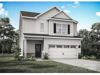 Charming two-story home with white siding, black shutters, and a two-car garage, surrounded by a well-manicured lawn at 1512 Doran Ter, Richburg, SC 29729