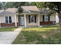 Charming single-story home featuring a well-maintained lawn, brick accents, and classic blue shutters at 1623 Flagler Ln, Charlotte, NC 28216