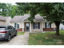 Charming single-story home with a well-manicured lawn, classic architecture, and a welcoming front entrance at 1623 Flagler Ln, Charlotte, NC 28216