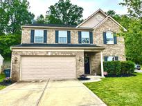 Charming two-story brick home with a well-manicured lawn and attached two car garage in a quiet suburban neighborhood at 16615 Crimson Sargent Dr, Charlotte, NC 28213