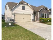 Charming single-Gathering home displaying a large driveway, two-car garage, and well-manicured lawn at 1825 Lotus Ln, Denver, NC 28037